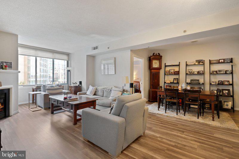 851 North Glebe Road, Unit 520 Arlington, VA 22203 - Photo 4 of 28 a living room with furniture wooden floor and a floor to ceiling window