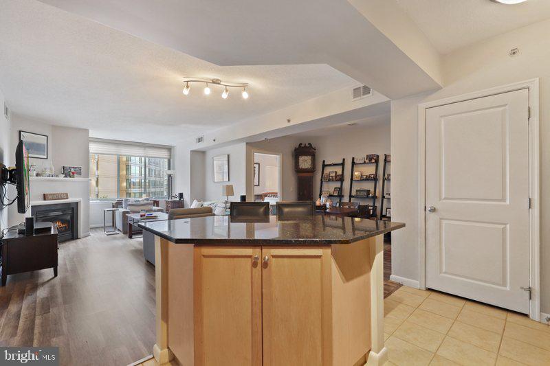 851 North Glebe Road, Unit 520 Arlington, VA 22203 - Photo 8 of 28 a view of living room with granite countertop furniture and fireplace