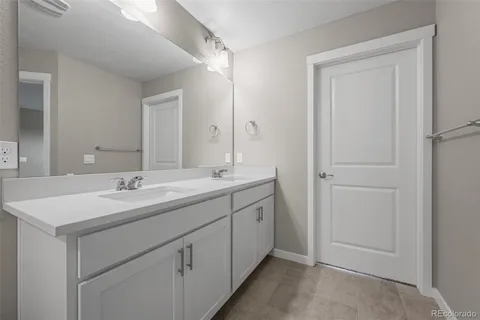 a bathroom with a sink a vanity and a mirror