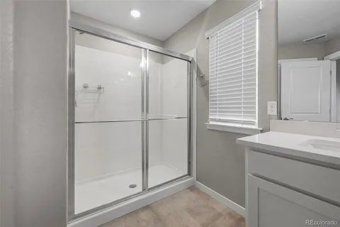 a bathroom with a shower and a sink