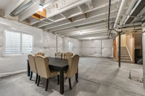 a dining room with furniture and a chandelier