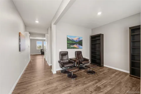 a view of a workspace with wooden floor and a window