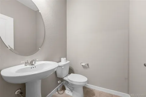 a bathroom with a sink a toilet and mirror