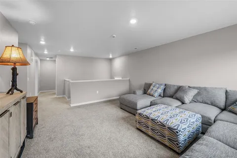 a living room with furniture and a lamp