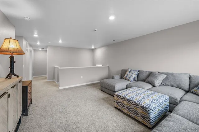 a living room with furniture and a lamp