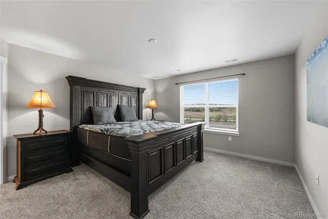 a bed sitting in a room next to a window