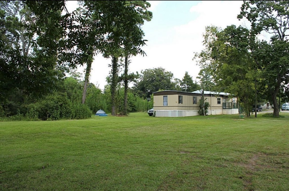 3318 Massey Tompkins Road Baytown, TX 77521 - Photo 4 of 7 a house with a tree in front of it