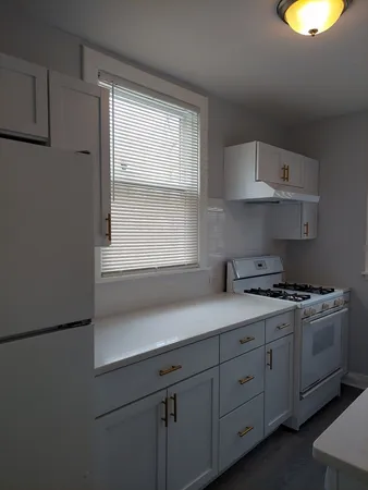a kitchen with appliances cabinets and a window