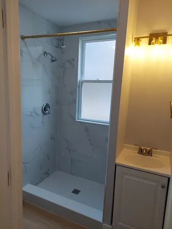 a bathroom with a shower and a sink