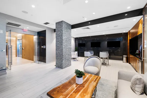 a living room with furniture and floor to ceiling window