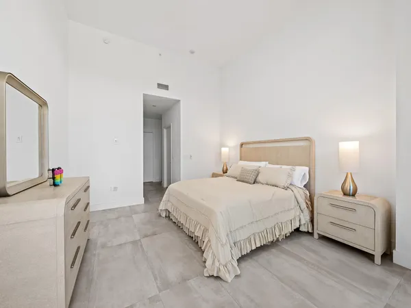 a bedroom with a bed and a couch