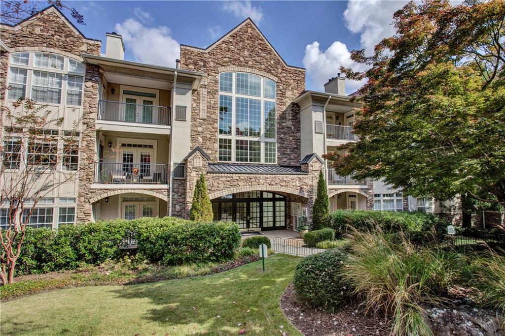 a front view of a residential apartment building with a yard