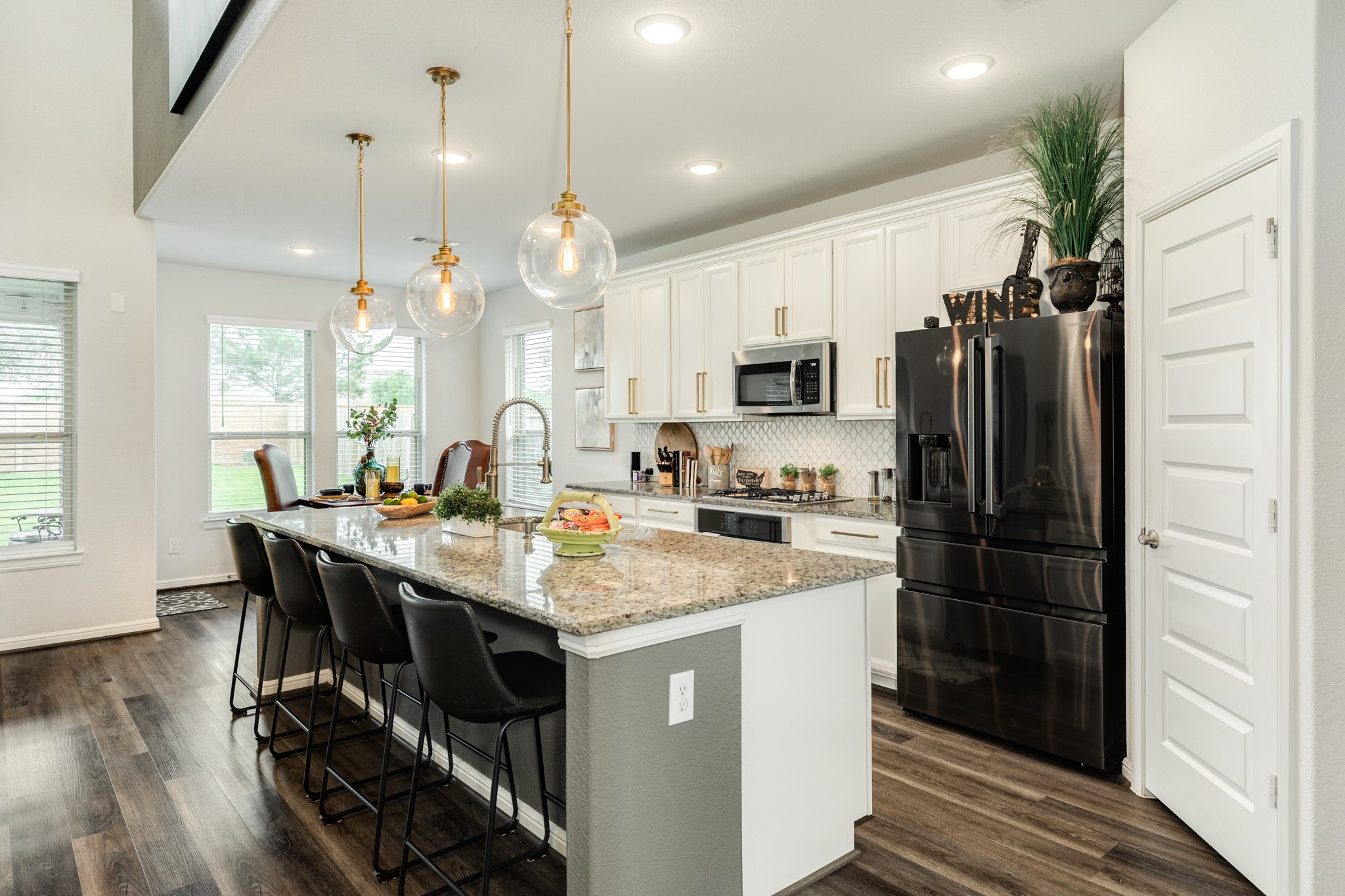 10306 Aldrin Drive Rosharon, TX 77583 - Photo 11 of 50 The kitchen area features a spacious, oversized island with a granite countertop, complemented by excellent pendant lighting. A pantry is conveniently located on your right.