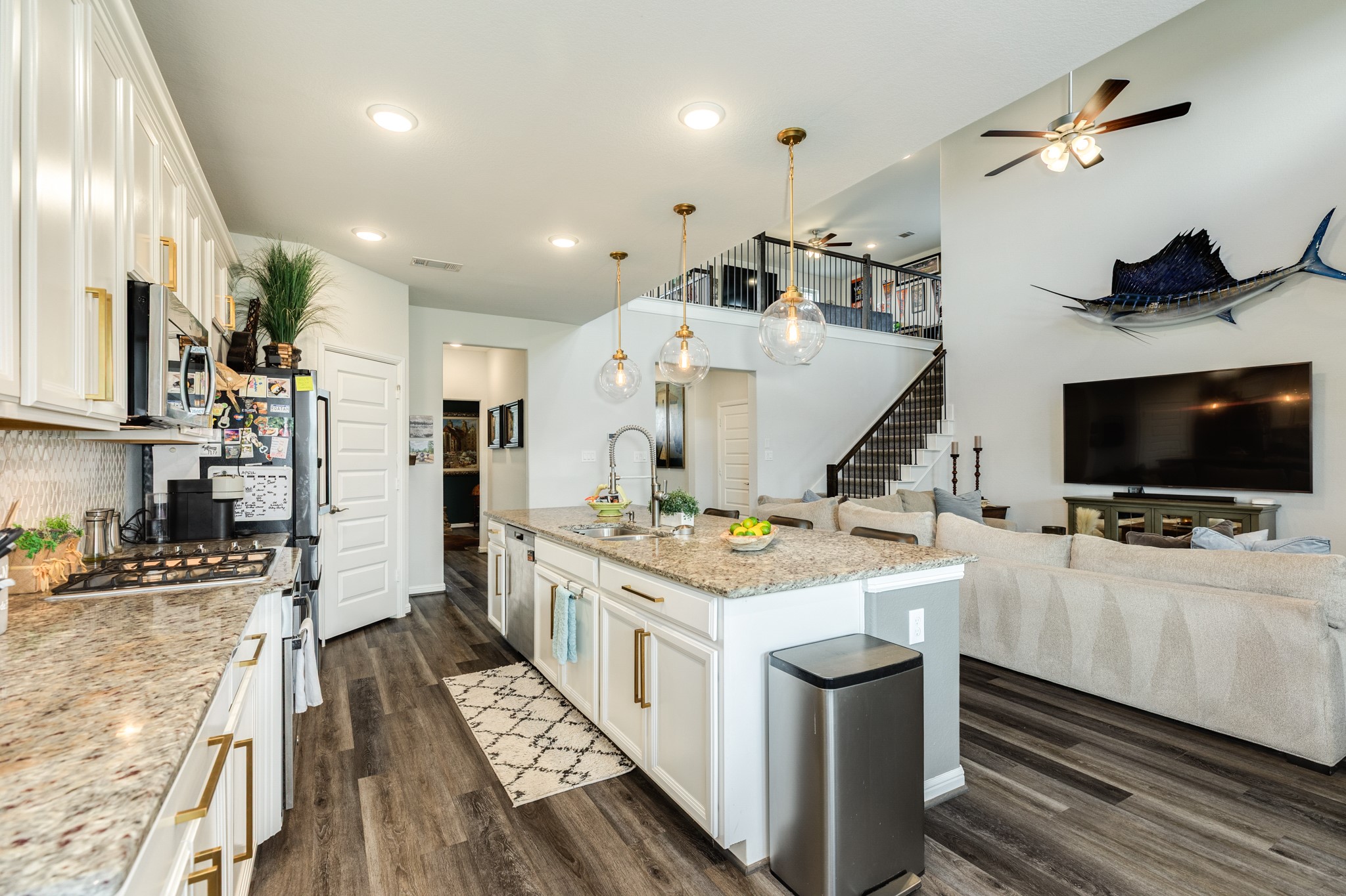 10306 Aldrin Drive Rosharon, TX 77583 - Photo 12 of 50 This view demonstrates the seamless transition from the front entrance, through the kitchen and family area, and up the stairs to the open game room.