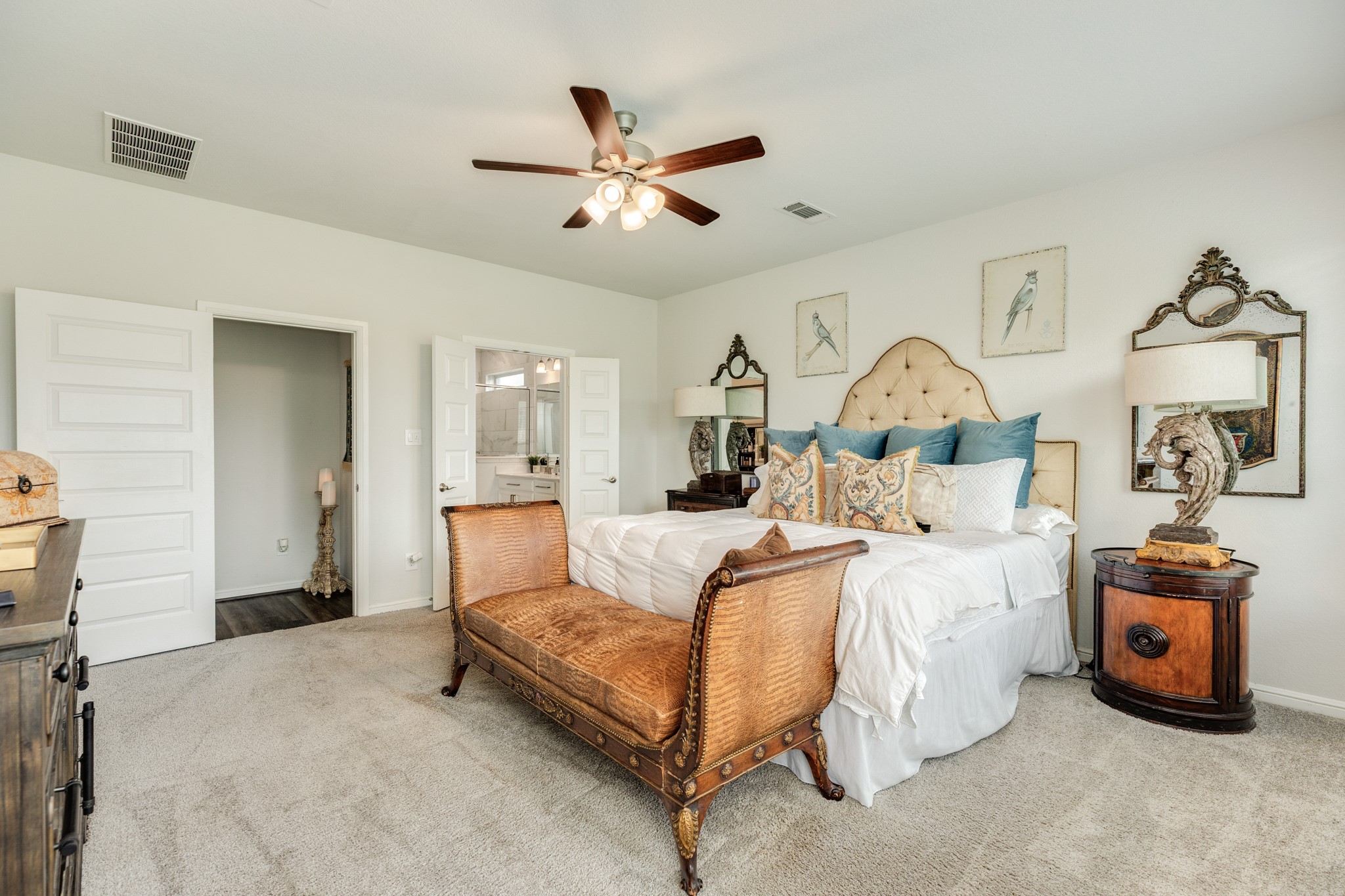 10306 Aldrin Drive Rosharon, TX 77583 - Photo 17 of 50 The primary suite is exceptionally spacious, featuring a ceiling fan and double doors providing access to the primary bath.