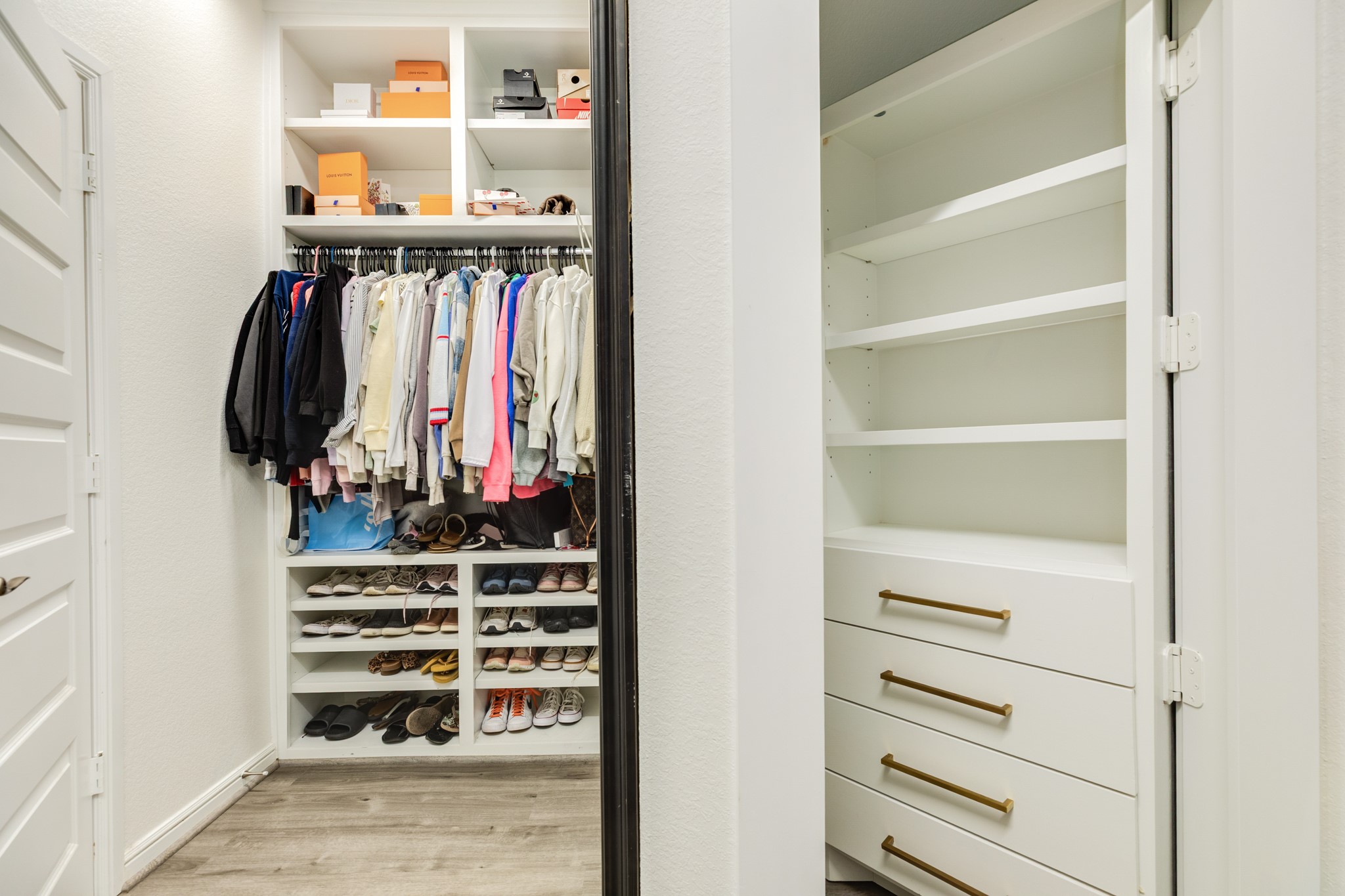 10306 Aldrin Drive Rosharon, TX 77583 - Photo 20 of 50 Primary Closet with Secret Room
The primary closet features a concealed room to the right, disguised as shelving and drawers for clothing storage. This hidden space is spacious enough to securely store items you wish to keep out of sight.