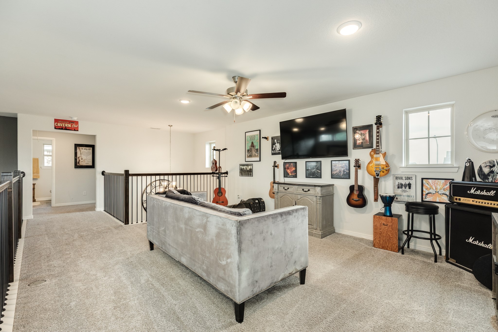 10306 Aldrin Drive Rosharon, TX 77583 - Photo 21 of 50 Upstairs features a game room with windows for ample natural light. The family room is also visible from the game room, creating an open and connected space.