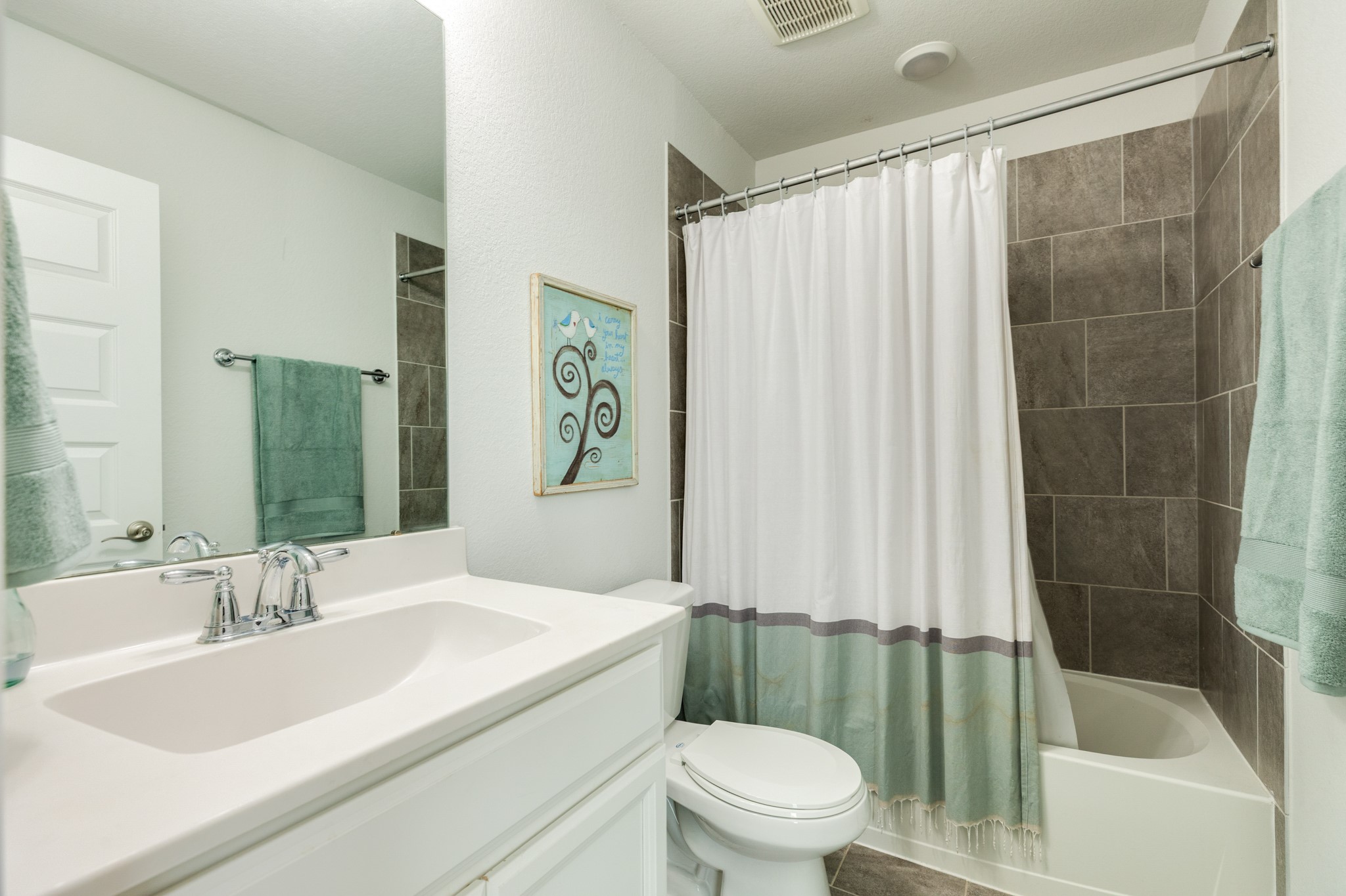 10306 Aldrin Drive Rosharon, TX 77583 - Photo 28 of 50 Guest bathroom featuring a shower/tub combination, quartz countertop, and oversized mirror.