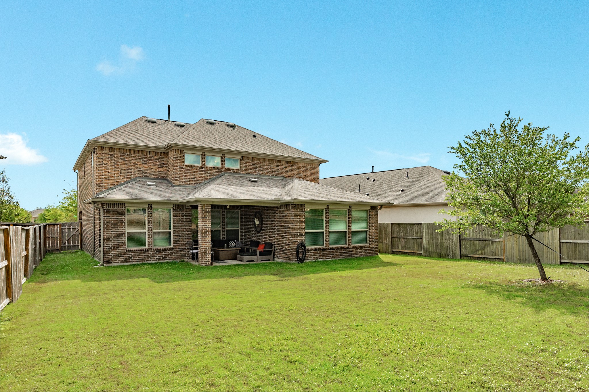 10306 Aldrin Drive Rosharon, TX 77583 - Photo 33 of 50 This home boasts a very large backyard, free from back neighbors, featuring a covered patio and a wall of windows, making it the perfect spot to watch the sunset