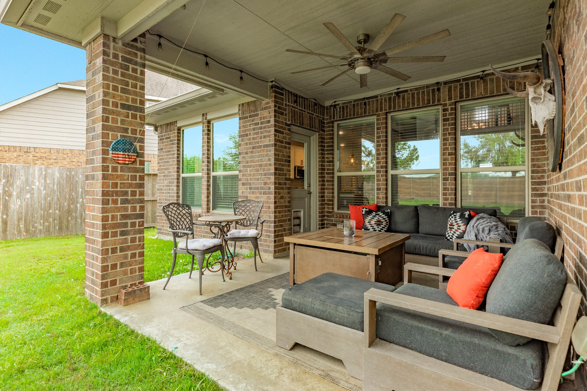 10306 Aldrin Drive Rosharon, TX 77583 - Photo 34 of 50 Close-up of the covered patio with ceiling fan, a great place to relax and enjoy sunsets, read, or watch the children play in the backyard.