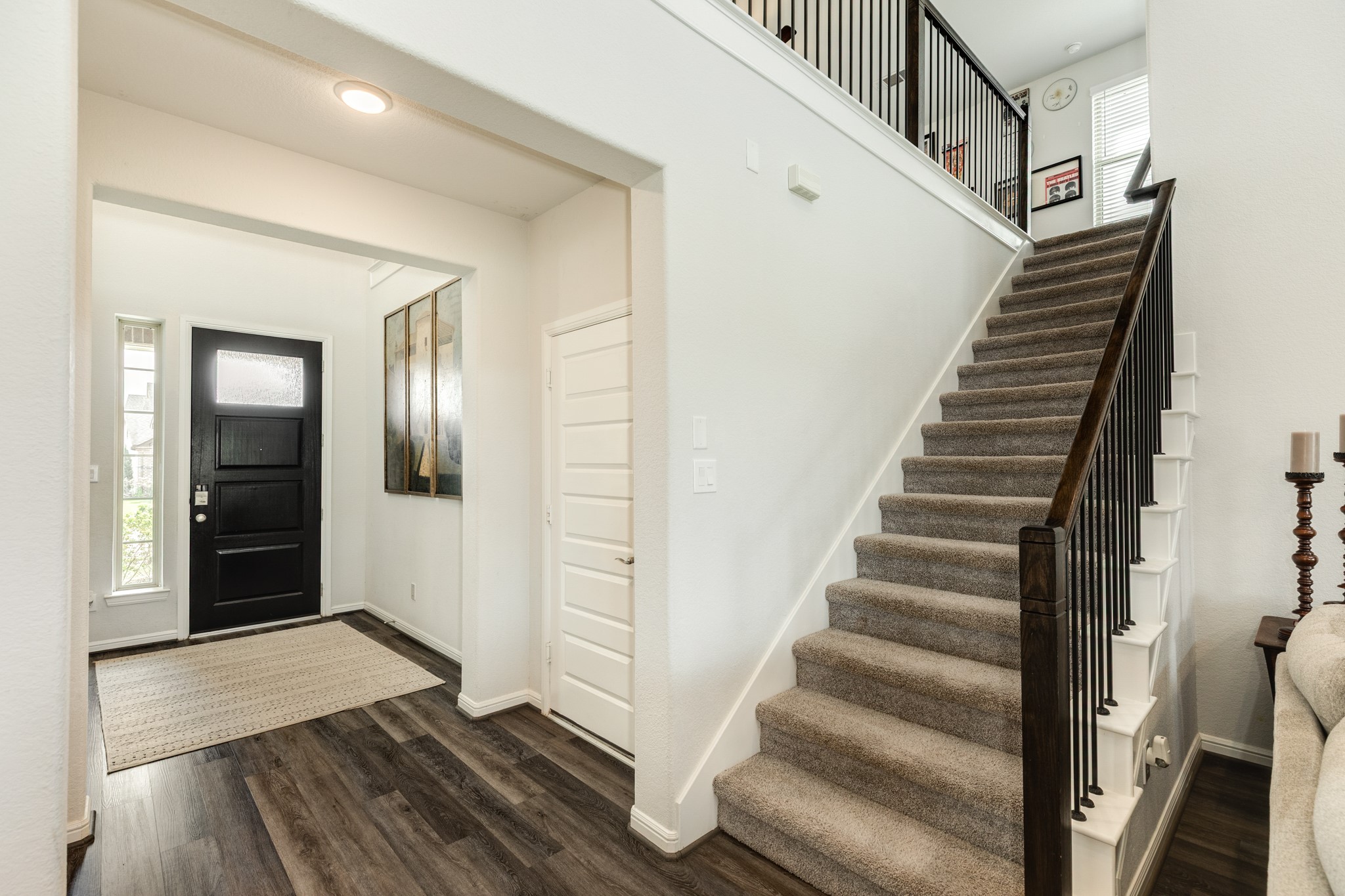 10306 Aldrin Drive Rosharon, TX 77583 - Photo 4 of 50 Upon entering through the front door, you are greeted with a relaxing room on your right, while the garage entrance is on the left, along with the stunning staircase.