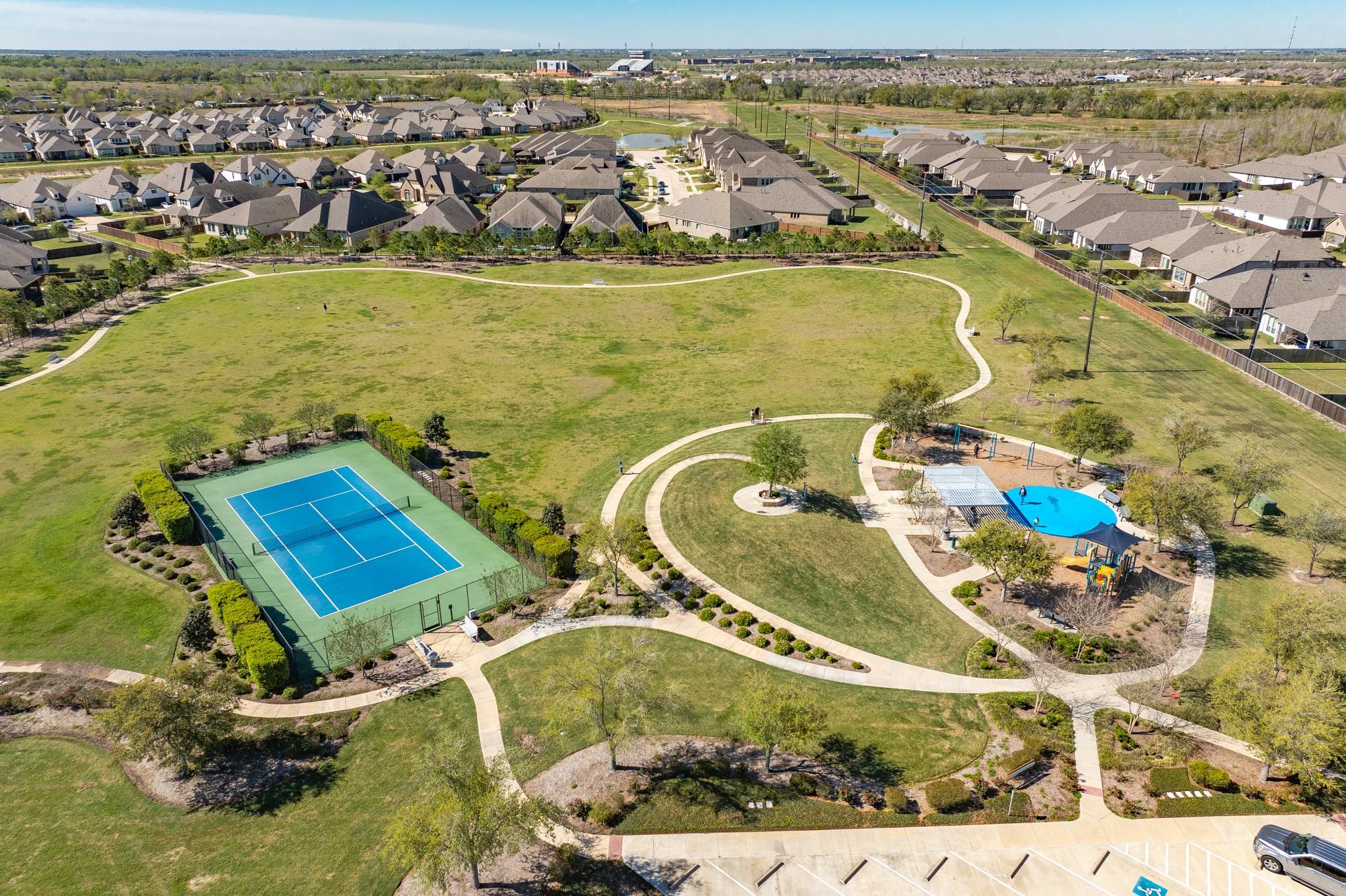 10306 Aldrin Drive Rosharon, TX 77583 - Photo 45 of 50 Features include tennis courts, a splash pad with playground, walking paths, and ample parking.