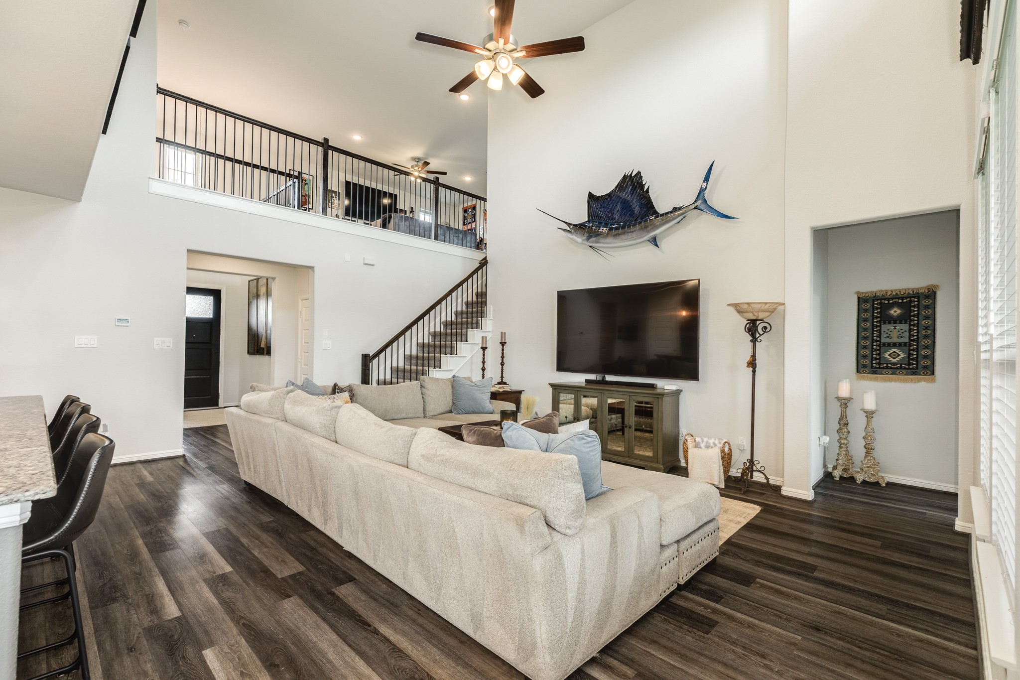 10306 Aldrin Drive Rosharon, TX 77583 - Photo 8 of 50 This view showcases the expansive game room located upstairs, easily accessible from the family room. To the right, you'll find the entrance to the primary bedroom and bathroom.