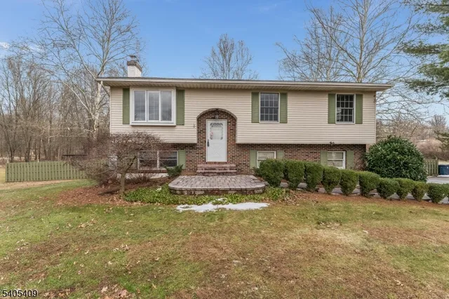 a front view of a house with a yard garage and outdoor seating