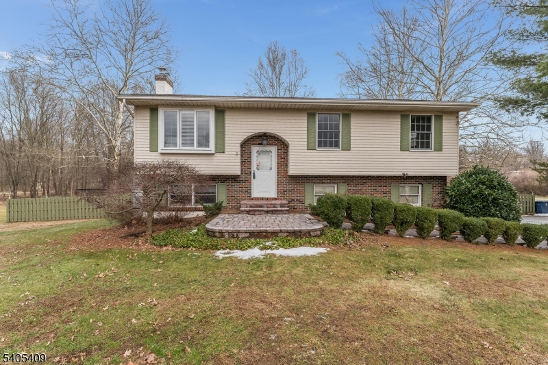 a front view of a house with a yard garage and outdoor seating