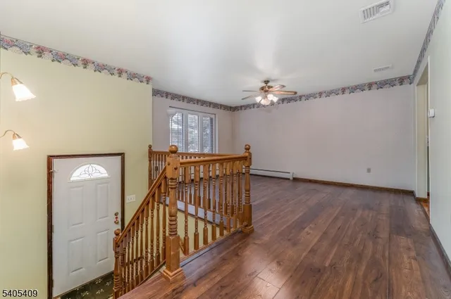 a view of a hallway with entryway wooden floor and front door