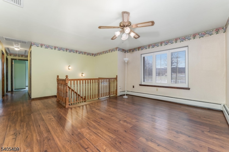 217 Van Syckles Road Hampton, NJ 08827 - Photo 4 of 16 a view of an empty room with wooden floor and a window