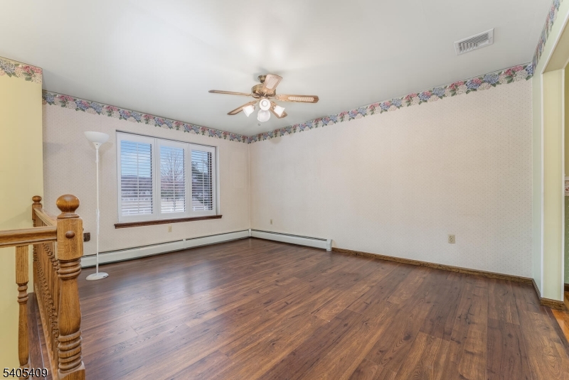 217 Van Syckles Road Hampton, NJ 08827 - Photo 5 of 16 a view of an empty room with a window and wooden floor