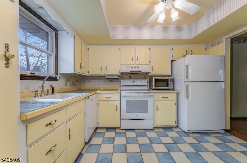 217 Van Syckles Road Hampton, NJ 08827 - Photo 6 of 16 a kitchen with a white cabinets and white appliances