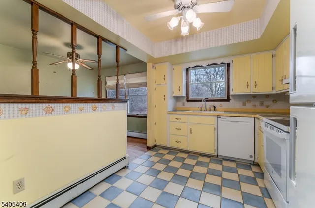 a kitchen with a sink a stove cabinets and counter space