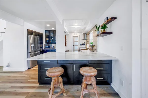 a kitchen with a stove a refrigerator and a dining table