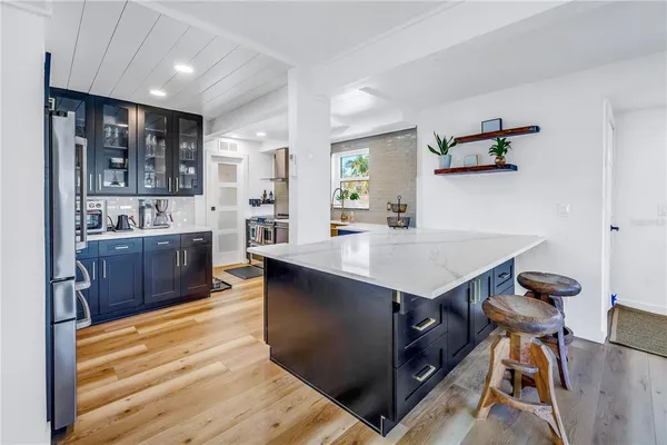 a kitchen with stainless steel appliances a sink and a refrigerator