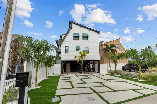 a view of house with swimming pool outdoor seating