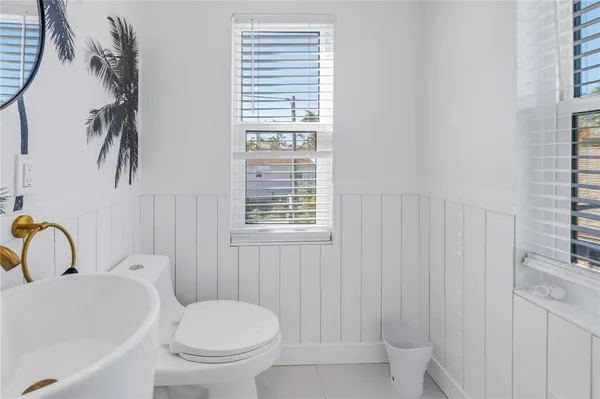 a living room with furniture a fireplace and a potted plant