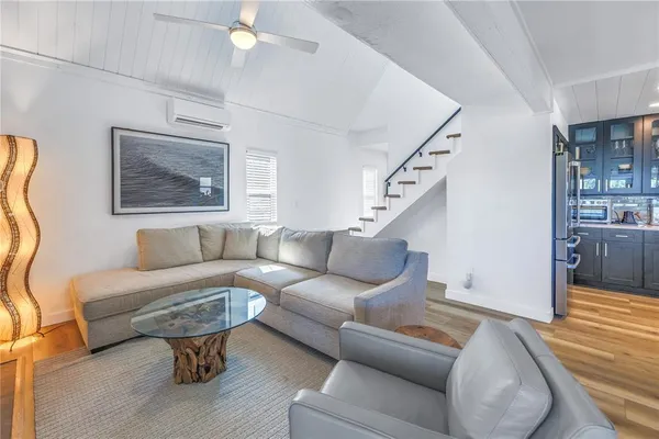 a living room with furniture and stairs