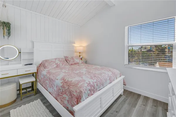 a bedroom with a bed and a dresser in it