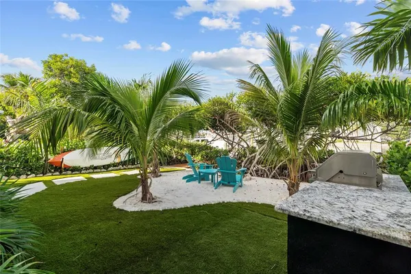 a view of a palm tree with a yard