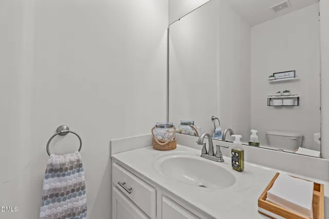 a bathroom with a toilet sink and shower curtain