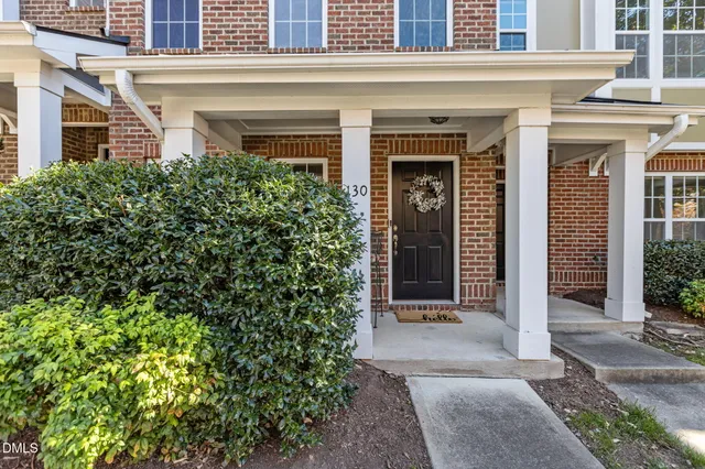 a view of balcony with two chairs and a potted plant