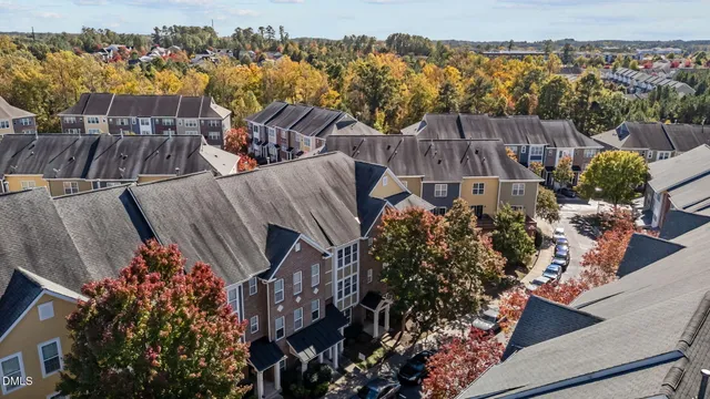 an aerial view of a house with a yard and balcony
