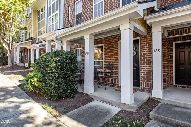 a front view of a building with a shower and a yard