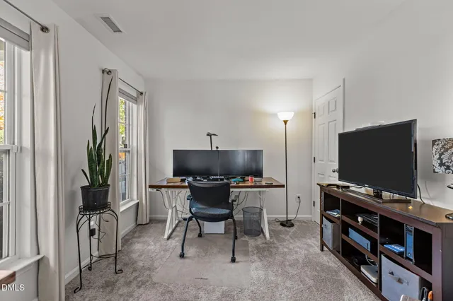 a view of a dining room that has a chandelier and a wooden floor