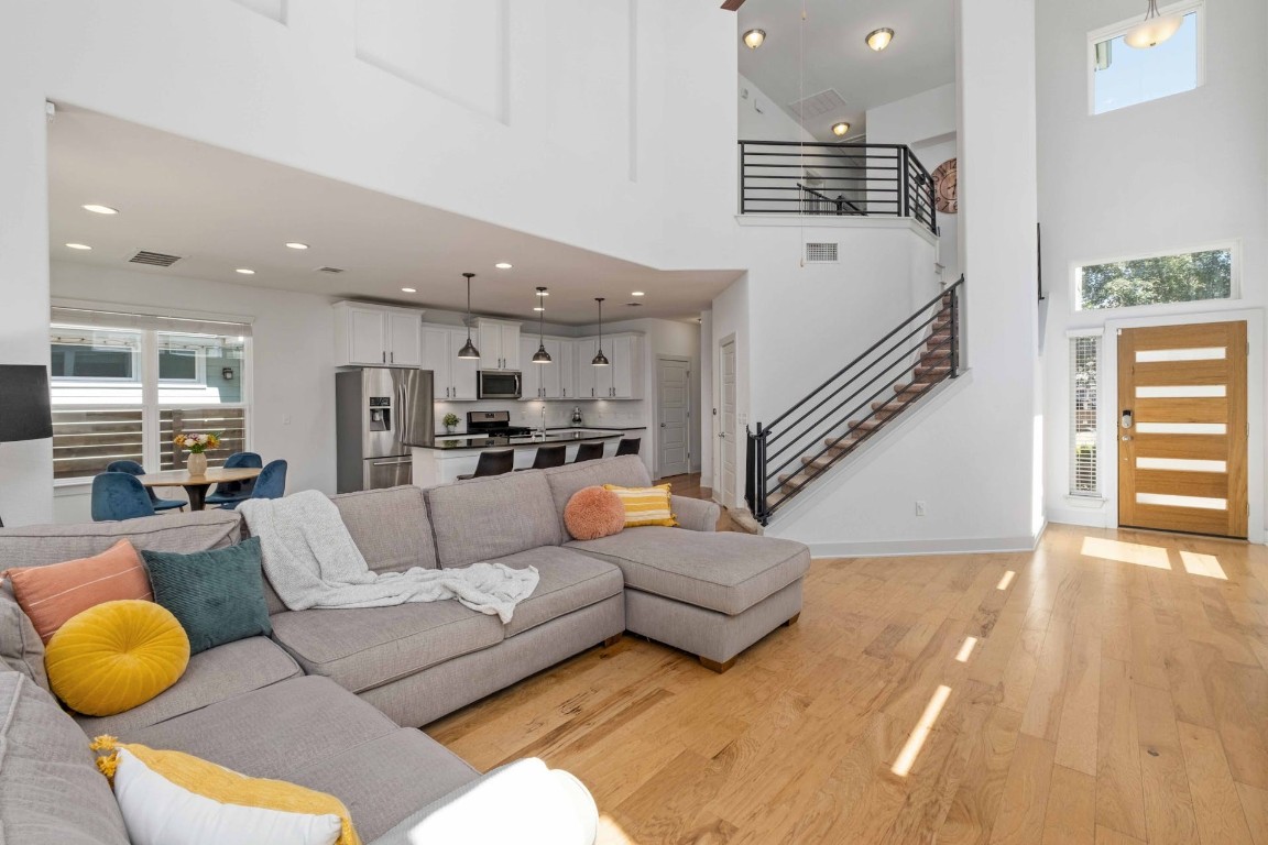 a living room with furniture and a wooden floor