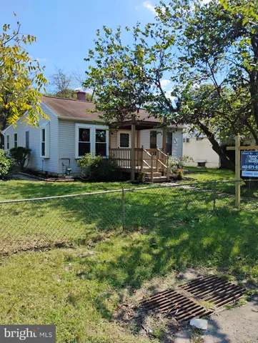 a house view with a sitting space and garden