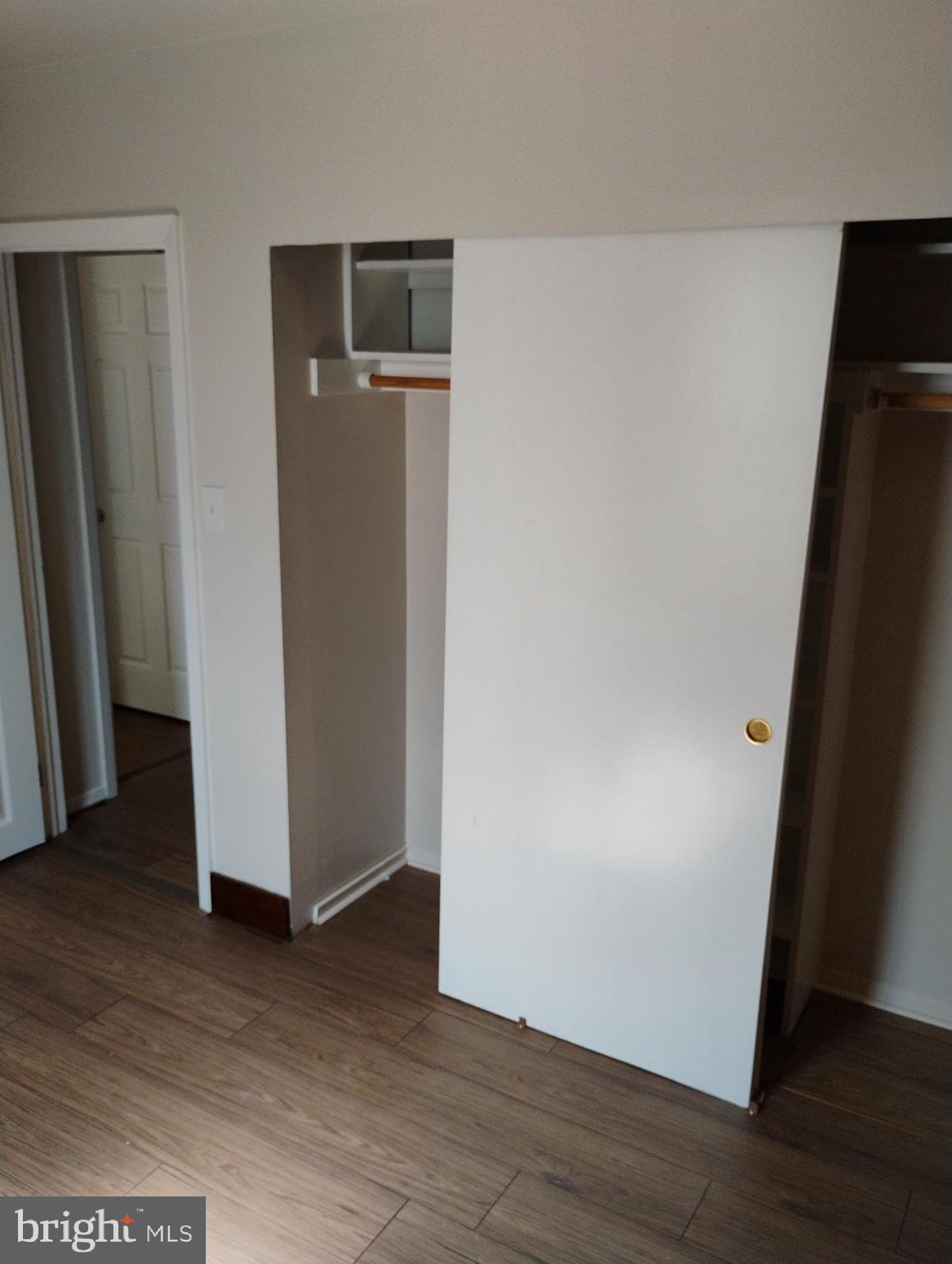 933 Andrews Road Glen Burnie, MD 21060 - Photo 13 of 22 an empty room with wooden floor and closet