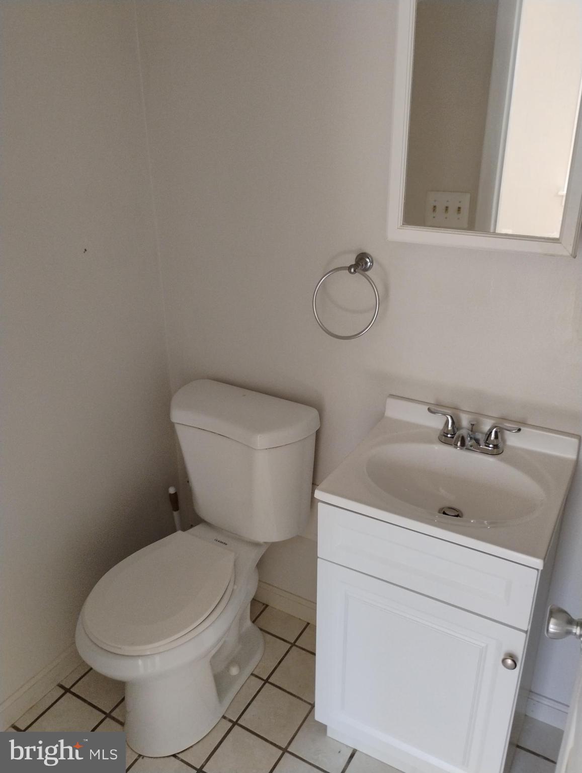 933 Andrews Road Glen Burnie, MD 21060 - Photo 15 of 22 a bathroom with a toilet sink and mirror